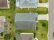 Overhead view of the house displaying its roof, landscaping, and proximity to neighboring properties at 2418 Hopespring Loop, The Villages, FL 32162