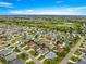 Overhead shot of neighborhood homes near a golf course and ponds, showcasing a picturesque community at 2418 Hopespring Loop, The Villages, FL 32162