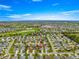 Expansive aerial view of the property nestled in a vibrant community with a nearby golf course at 2418 Hopespring Loop, The Villages, FL 32162