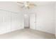 Comfortable bedroom with carpet, a ceiling fan, and closet space at 2418 Hopespring Loop, The Villages, FL 32162