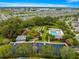 Bird's eye view of the community pool, shuffleboard, and manicured gardens in a park-like setting at 2418 Hopespring Loop, The Villages, FL 32162