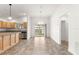 Dining area with tile floors, sliding glass doors to the backyard, and a view of the kitchen at 2418 Hopespring Loop, The Villages, FL 32162