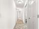 Bright hallway with tile flooring and multiple doors leading to different areas of the home at 2418 Hopespring Loop, The Villages, FL 32162