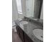 Bathroom featuring a double-sink vanity with sleek fixtures and a well-lit mirror and a view of toilet and bath at 2792 Sw 161St Loop, Ocala, FL 34473