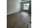 Sunlit bedroom with wood-look floors and a large window at 2792 Sw 161St Loop, Ocala, FL 34473