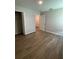 Bright bedroom featuring wood flooring, a walk-in closet, and a doorway to other rooms of the home at 2792 Sw 161St Loop, Ocala, FL 34473
