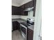 Efficient kitchen space with dark wood cabinets, stainless steel appliances, and granite countertops at 2792 Sw 161St Loop, Ocala, FL 34473