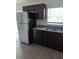 Efficient kitchen space with dark wood cabinets, stainless steel appliances, and a dual basin sink at 2792 Sw 161St Loop, Ocala, FL 34473