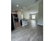 Bright and open living area with wood-look floors, recessed lighting, and modern kitchen at 2792 Sw 161St Loop, Ocala, FL 34473