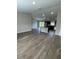 Open living room and kitchen area with modern wood-look flooring and plenty of natural light at 2792 Sw 161St Loop, Ocala, FL 34473