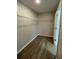 Spacious walk-in closet with built-in shelving and wood-look floors at 2792 Sw 161St Loop, Ocala, FL 34473