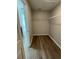 Walk-in closet featuring built-in shelving and wood-look floors at 2792 Sw 161St Loop, Ocala, FL 34473