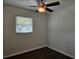 Simple bedroom with dark wood floors and a ceiling fan at 3333 Se 12Th St, Ocala, FL 34471