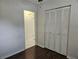 Bedroom with dark wood floors and built-in closet at 3333 Se 12Th St, Ocala, FL 34471