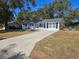 Newly painted house with a spacious yard and long driveway at 3333 Se 12Th St, Ocala, FL 34471