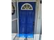 Charming blue front door with a half-round window at 3333 Se 12Th St, Ocala, FL 34471