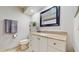 Bathroom featuring a vanity with a granite countertop, a toilet, and a decorative mirror at 35428 Crescent Dr, Fruitland Park, FL 34731