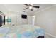 A bedroom featuring a bed, a ceiling fan, and an ensuite bathroom, closet, and television at 35428 Crescent Dr, Fruitland Park, FL 34731