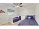 Bedroom featuring two twin beds, neutral decor, and a window that allows natural light at 35428 Crescent Dr, Fruitland Park, FL 34731