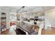 Open dining area with a modern light fixture adjacent to the kitchen with stainless steel appliances at 35428 Crescent Dr, Fruitland Park, FL 34731