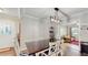 Dining room with hardwood floors, stylish lighting, and views to the living room at 35428 Crescent Dr, Fruitland Park, FL 34731