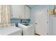 Bright laundry room with washer, dryer, and ample cabinets at 35428 Crescent Dr, Fruitland Park, FL 34731