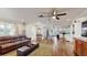 Open concept living room with hardwood floors and view into dining area at 35428 Crescent Dr, Fruitland Park, FL 34731