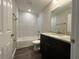 Clean bathroom, granite vanity, and a bathtub at 3957 Se 137Th Ln, Summerfield, FL 34491