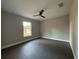 Simple bedroom with vinyl plank flooring and a window at 3957 Se 137Th Ln, Summerfield, FL 34491