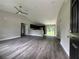 Open living room with vinyl plank flooring, leading to kitchen and other rooms at 3957 Se 137Th Ln, Summerfield, FL 34491