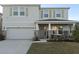 Two-story house with light gray siding, stone accents, and a two-car garage at 4321 Sw 52Nd Lane Rd, Ocala, FL 34474