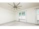 Bright bedroom with neutral carpet, ceiling fan, and ample natural light from the windows at 4721 Se 25Th Loop, Ocala, FL 34480