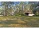 Large backyard with detached storage shed and mature trees at 5000 Se 11Th Ave, Ocala, FL 34480