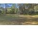 Open grassy backyard providing ample space for outdoor activities at 5000 Se 11Th Ave, Ocala, FL 34480