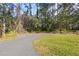 Circular driveway and basketball court surrounded by trees at 5000 Se 11Th Ave, Ocala, FL 34480