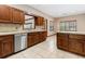 Open kitchen with an island, stainless steel appliances, and wood cabinets at 5000 Se 11Th Ave, Ocala, FL 34480