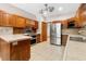 This kitchen features wood cabinets, stainless steel appliances, and tile flooring at 5000 Se 11Th Ave, Ocala, FL 34480