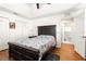 Bedroom with a dark wood bed frame and ensuite bathroom at 5137 Nw 20Th Pl, Ocala, FL 34482