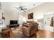 Bright living room featuring hardwood floors and a flat-screen TV at 5137 Nw 20Th Pl, Ocala, FL 34482