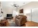 Spacious living room with hardwood floors and a view to the kitchen at 5137 Nw 20Th Pl, Ocala, FL 34482