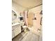 Bathroom featuring a vanity, toilet, and walk-in shower with pink tile and matching curtain at 5625 Sw 181St Ct, Dunnellon, FL 34432