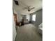 Bedroom featuring an armchair, window, and door with carpeted floors at 5625 Sw 181St Ct, Dunnellon, FL 34432