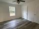 Spacious bedroom with large window, ceiling fan and vinyl flooring at 5739 Se 163Rd Ct, Ocklawaha, FL 32179