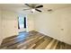 Spacious bedroom with ceiling fan and vinyl plank flooring at 5739 Se 163Rd Ct, Ocklawaha, FL 32179