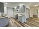 Modern kitchen with gray cabinets, granite countertops, and stainless steel sink at 5739 Se 163Rd Ct, Ocklawaha, FL 32179