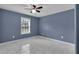 Cozy bedroom with ceiling fan, window, and marble floors at 5885 Sw 169Th Ct, Ocala, FL 34481