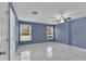 Light-filled bedroom with a ceiling fan, two windows and neutral-colored walls at 5885 Sw 169Th Ct, Ocala, FL 34481