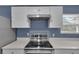 Close-up of kitchen with stainless steel range and white cabinets at 5885 Sw 169Th Ct, Ocala, FL 34481