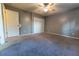 Bedroom with carpeted floor, ceiling fan, and double closet at 6006 Nw 62Nd Pl, Ocala, FL 34482