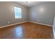 Bedroom with wood-look floors and neutral walls at 6006 Nw 62Nd Pl, Ocala, FL 34482